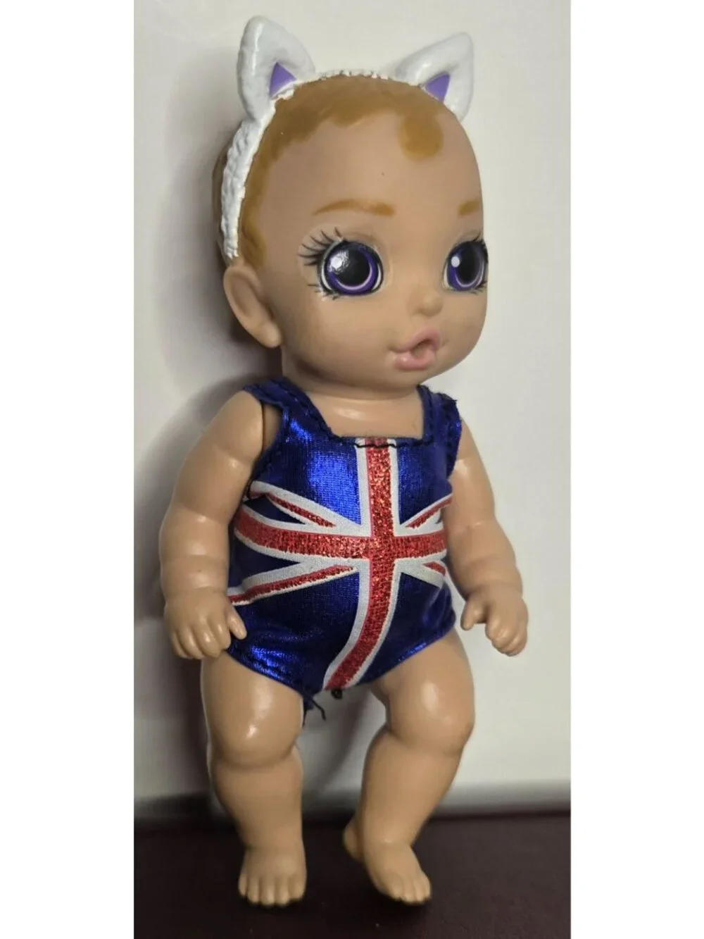 Zapf Creations Baby Born Mini Surprise Doll With Union Jack Swimsuit